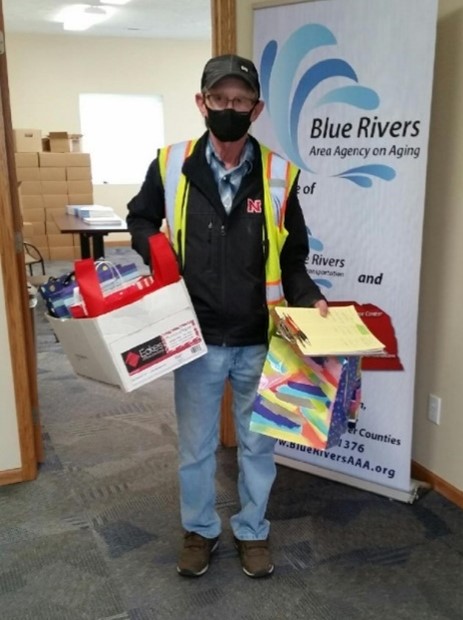 Photo of a driver from Blue Rivers AAA getting ready to head out with promo items to gift passengers during Nebraska Public Transit Week 2021